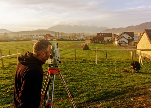 land surveying concept, working and taking measures with total station on construction site.