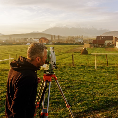 land surveying concept, working and taking measures with total station on construction site.